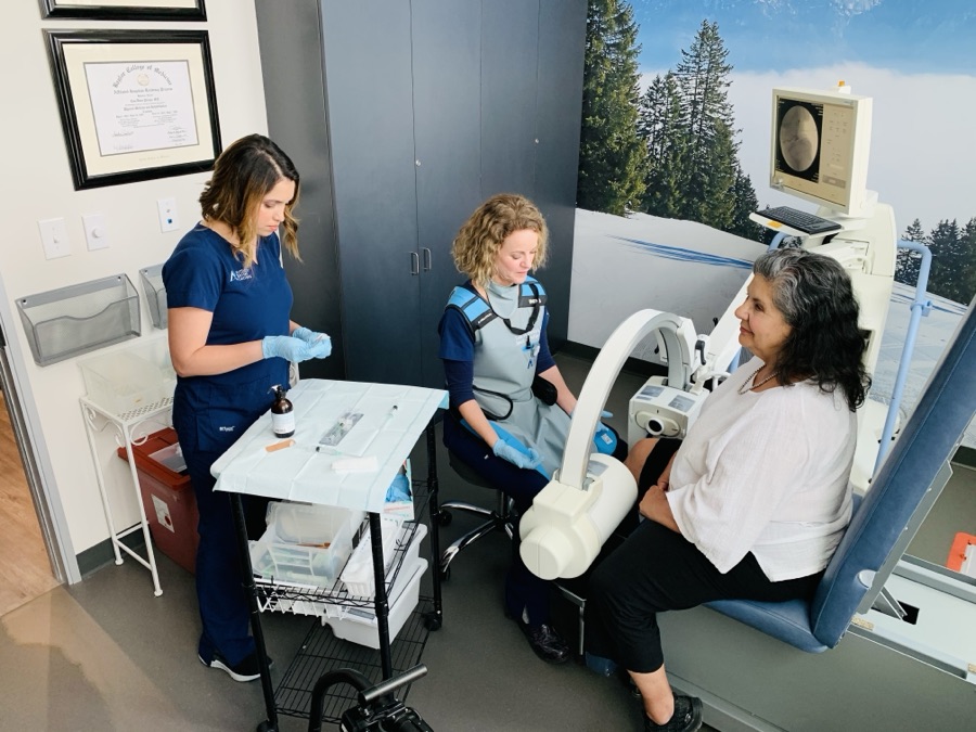 Dr. Persyn and a medical assistant preparing a patient&rsquo;s knee injection under the mini C-arm at ARV Centers