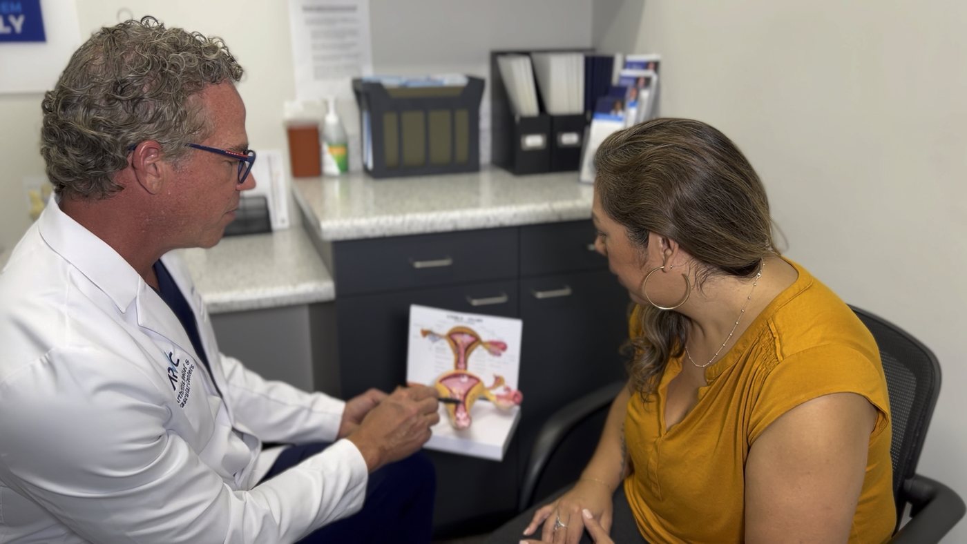 An ARV Centers physician going through a uterine fibroid diagram with a patient during a consultation in San Antonio